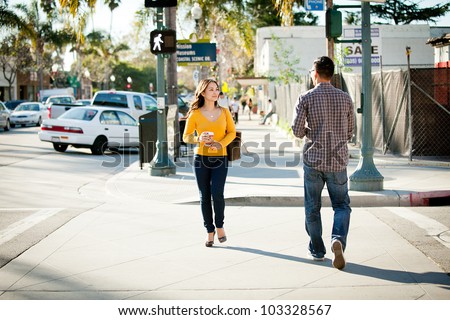 Young couple walking opposite seeing each other