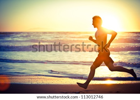 Man running on the beach at sunset Man running on the beach at sunset