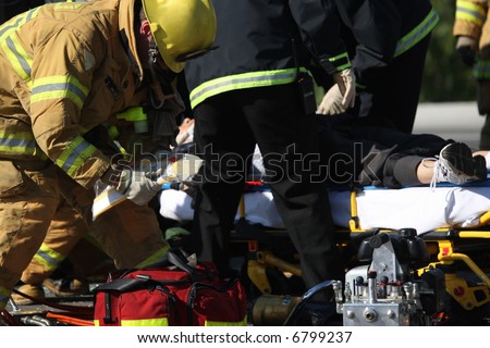 Emergency crew removing a victim from a car accident