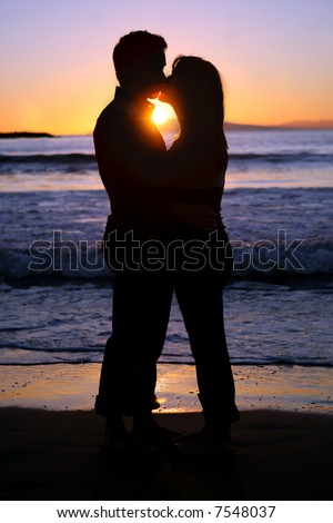 couple kissing silhouette image. a young couple kissing at