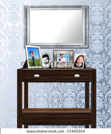 Interior of table, mirror and family photos against antique victorian wallpaper