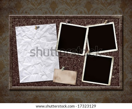 Cork board with grungy blank photos and crinkled paper - with copy space