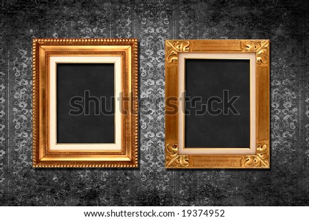 Antique frames on red grungy victorian wallpaper