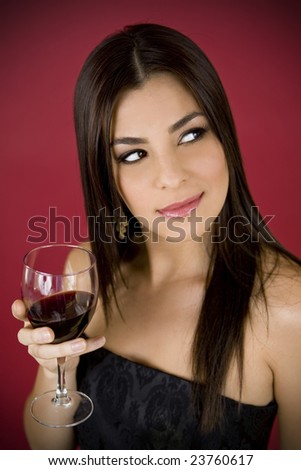 Beautiful woman drinking a glass of red wine