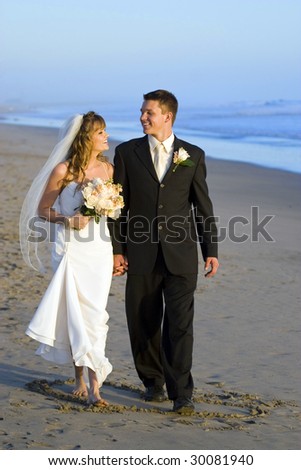 stock photo Loving wedding couple walking on the beach