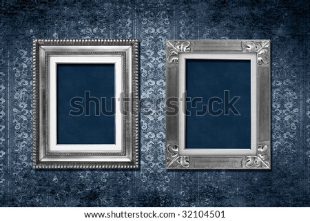 Antique frames on blue grungy victorian wallpaper