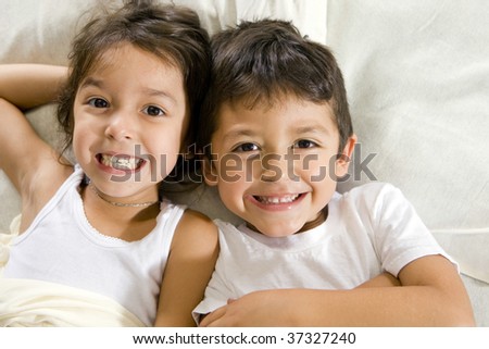 Cute brother and sister laying in bed