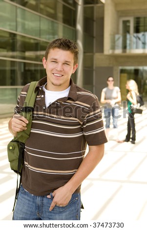 Young man at school holding a book bag