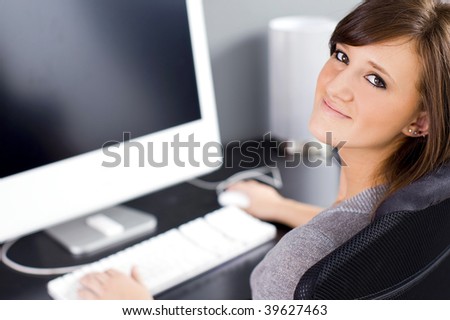 Pretty young girl working at her computer