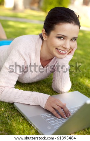 Young student using computer outside