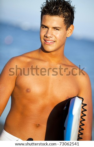Young man at the beach with a boogie board