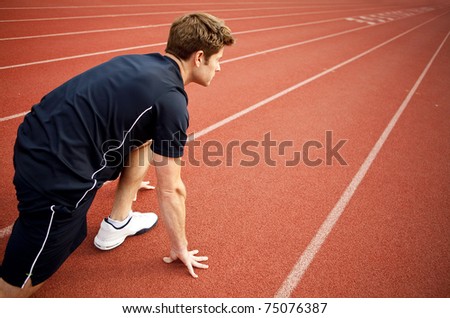 Man ready to start running on a track