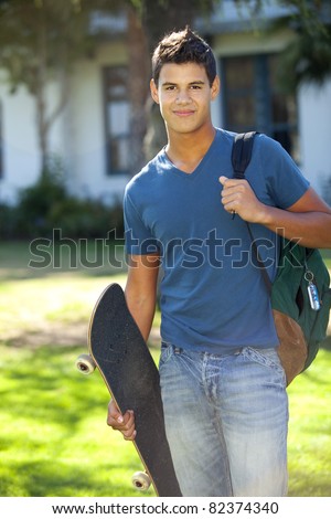 Student with skateboard and backpack outside school