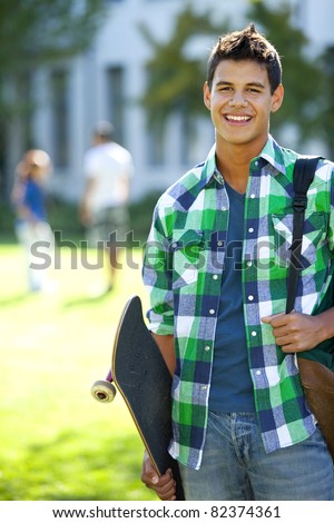 Student with skateboard and backpack outside school