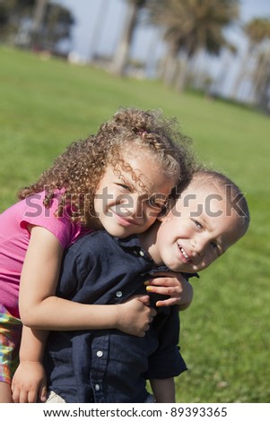Brother and sister playing at a park