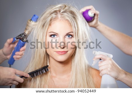 Beautiful woman surrounded by hair care tools