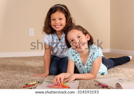 Cute little sisters coloring together