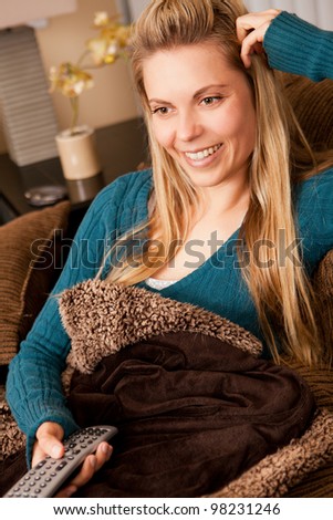 Pretty young woman lounging on a couch