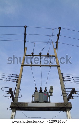 Electricity post with transformer on blue sky background