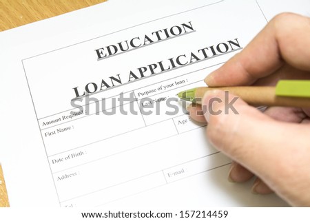 Man filling out a education loan application