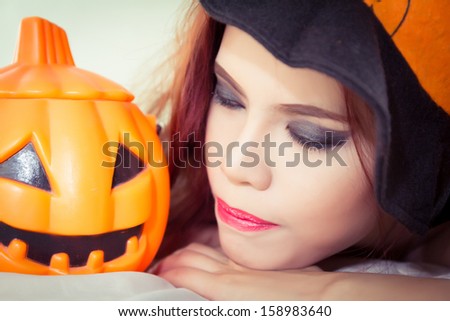 Women\'s Halloween hat and pumpkin in concept halloween