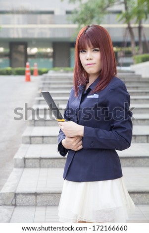 asian beautiful business woman with folder at modern building