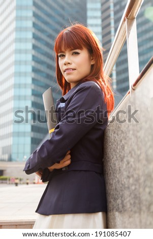 asian beautiful business woman with folder at modern building