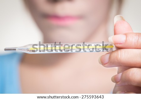 Sick woman  show hand holding clinical  thermometer