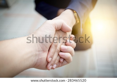 Business women handshake on bright background Business women handshake on bright background