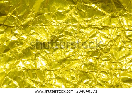 Gold creased paper background texture. Gold paper sheet.