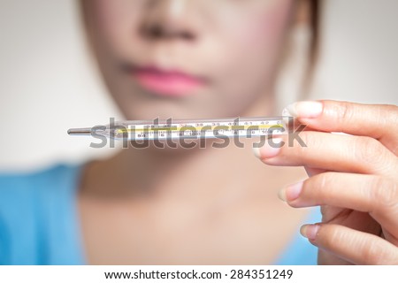 Sick woman  show hand holding clinical  thermometer