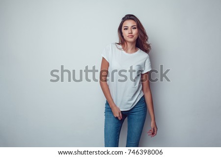 Sexy woman in a white T-shirt on a gray background. Mock-up.