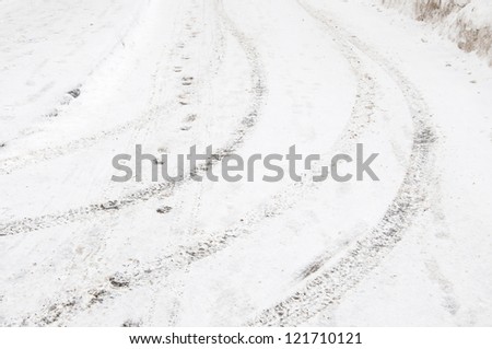 Tyre tracks and footsteps in a fresh snow