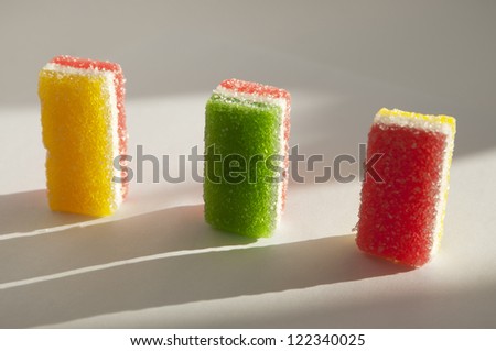 Different fruit-paste candies on a white paper in a sunlight
