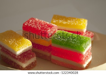 Different fruit-paste candies on a small plate in a sunlight