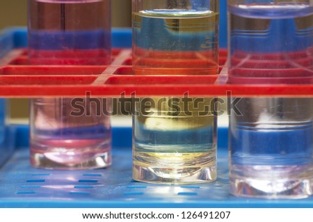 Test tubes with different colored chemicals in a plastic support