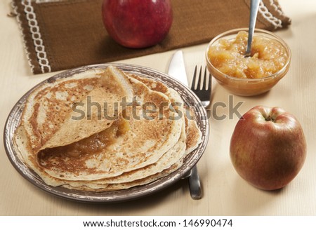 Home-made pancakes with apple jam and apples