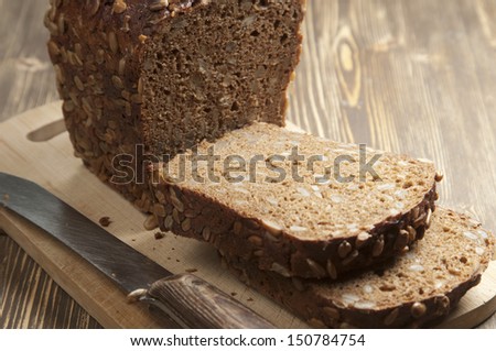 Rye and wheat bread with sunflower seeds on a wooden table