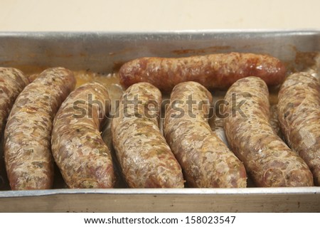 Several fried sausages on a sheet pan