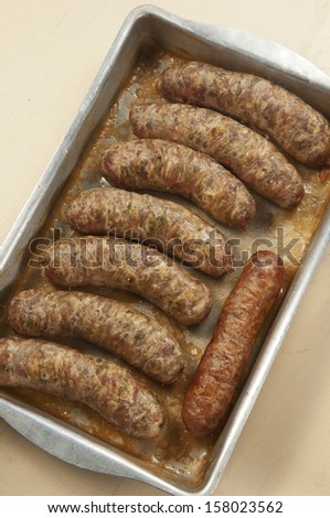 Several fried sausages on a sheet pan