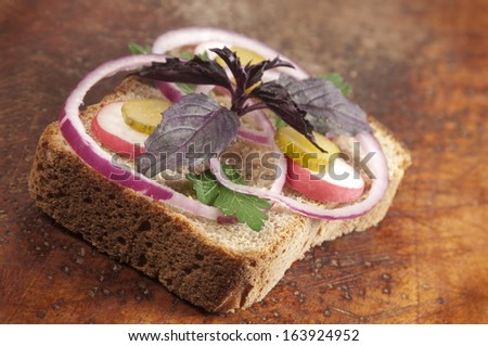 Hot vegetable sandwich on a wooden board