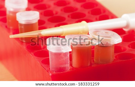 Test tubes with different colored chemicals in a plastic support and dosage unit