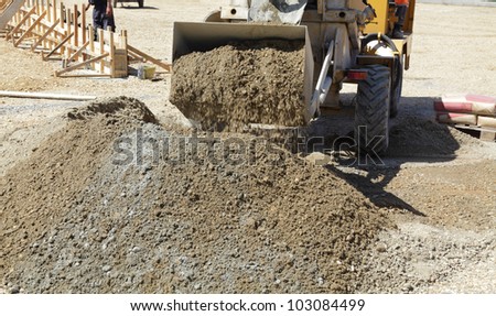 Self loading concrete mixer  taking gravel and sand to bucket