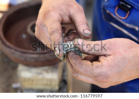 Mechanic lubricate a roller bearing with lithium grease