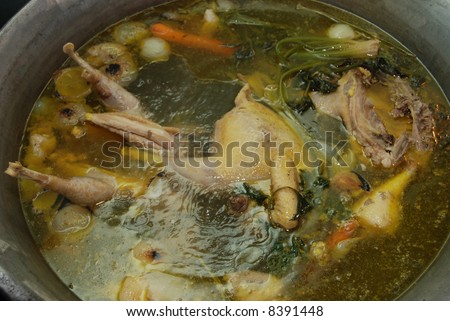 Cooking chicken soup in big pot