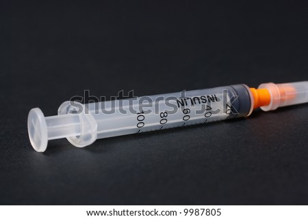 Syringe for insulin in close up isolated on black