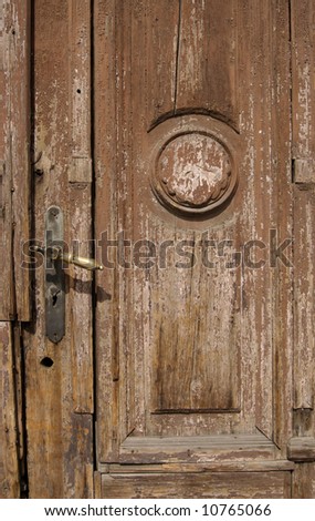 Lock on old brown ruined wooden door