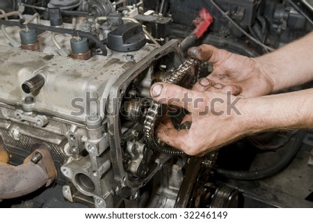 Repairing of diesel engine close up of worker hands