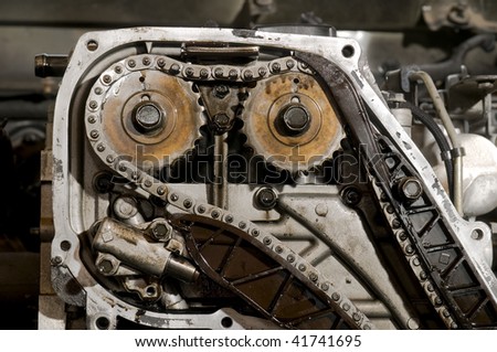 Close up of car engine camshaft gear and chain, two camshaft system