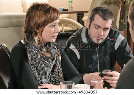 Young people sitting in cafe and talking